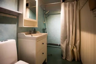 a bathroom with a sink and a shower curtain at Trysilfjellet Nord 1071B in Trysil