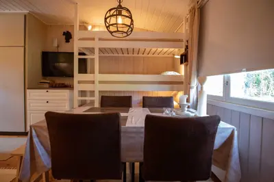 a dining room with a table and chairs at Trysilfjellet Nord 1071B in Trysil