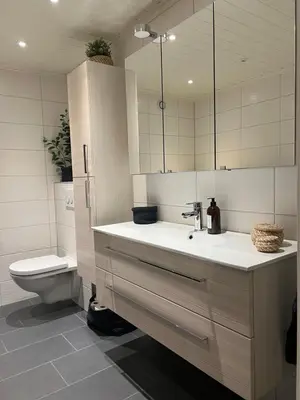 a bathroom with a sink and a toilet and a mirror at House with 5 bedrooms very close to World Cup 25 in Granåsen in Trondheim