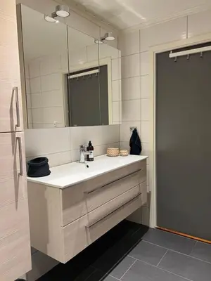 a bathroom with a sink and a large mirror at House with 5 bedrooms very close to World Cup 25 in Granåsen in Trondheim