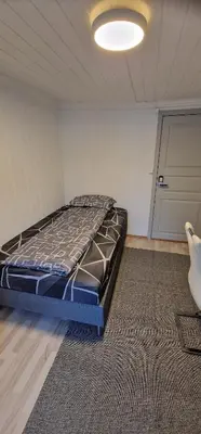 a bedroom with a bed in a room with a door at Storgata 36B in Lillehammer