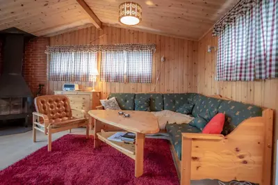 a living room with a couch and a table at Trysilfjellet Nord 1017 in Trysil