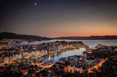 a view of a city with a harbor at night at DINBNB Apartments Private terrace l 700 m to Bryggen l Modern in Bergen