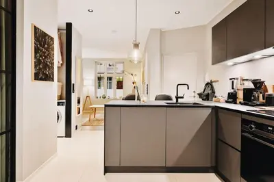 a kitchen with a sink and a counter top at DINBNB Apartments Private terrace l 700 m to Bryggen l Modern in Bergen