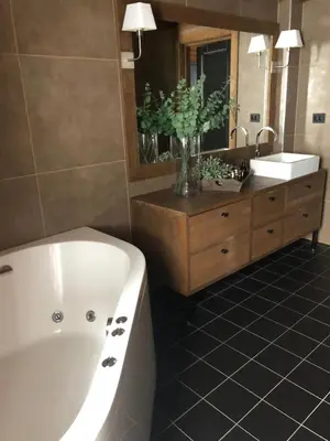 a bathroom with a tub and a sink and a mirror at Wonderful Ski-In, ski-out Cabin at Kvitfjell in Strande