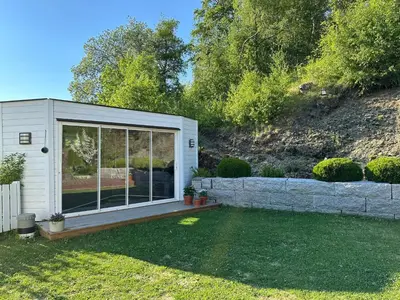 a tiny house with a large window in a yard at Granåsen ski-VM in Trondheim