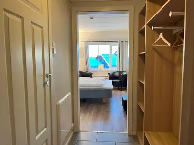 a door to a room with a bedroom and a bed at Bitihorn fjellbris in Beitostøl