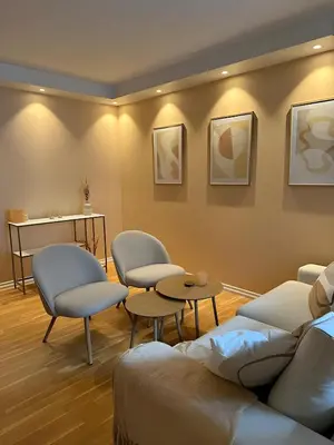 a waiting room with chairs and a table at Modern and chic city apartment - Bergen City in Bergen