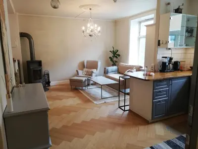 a kitchen and living room with a table and chairs at Beautiful and central apartment for rent during Ski WC 2025 in Trondheim