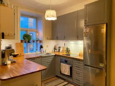 a kitchen with a stainless steel refrigerator and a sink at Beautiful and central apartment for rent during Ski WC 2025 in Trondheim