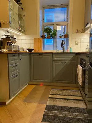 a kitchen with gray cabinets and a window at Beautiful and central apartment for rent during Ski WC 2025 in Trondheim