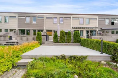 a house with a wooden walkway in front of it at Spacious and Peaceful Home with a Private Gym in Trondheim