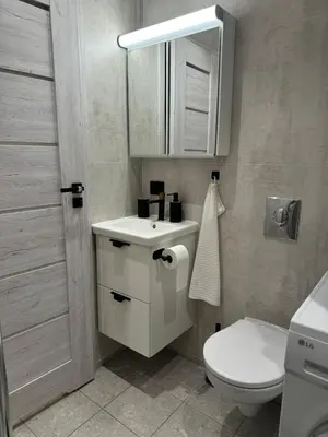 a bathroom with a white toilet and a sink at FjordView in Stranda