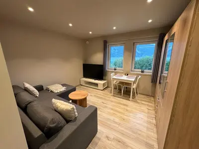 a living room with a couch and a table at FjordView in Stranda