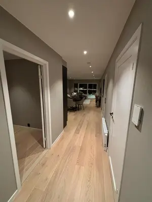 an empty hallway with a door open to a living room at Modern Appartement - Ski World Cup 2025 in Trondheim