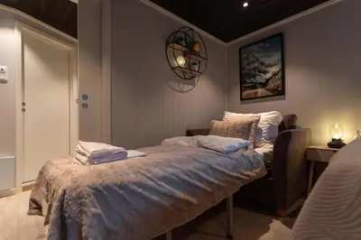 a bedroom with a bed with towels on it at Studio Plassen in Sogndal