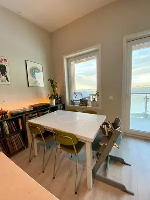 a dining room with a white table and chairs at Hus til leie under VM 2025 in Trondheim