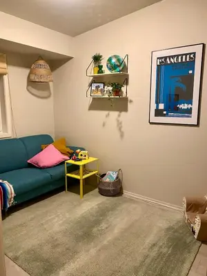 a living room with a blue couch and a table at Hus til leie under VM 2025 in Trondheim