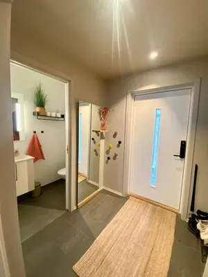 an empty room with a door and a bathroom at Hus til leie under VM 2025 in Trondheim