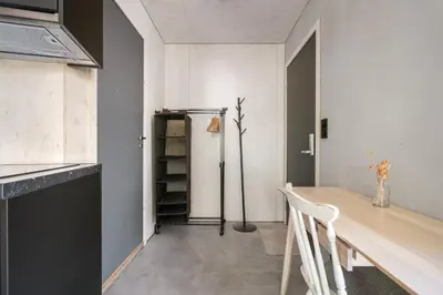 a dining room with a table and a refrigerator at Architectural Studio I Private Balcony in Bergen