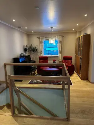 a living room with a glass table in a room at World championship ski 2025-Cozy house for rent in Trondheim