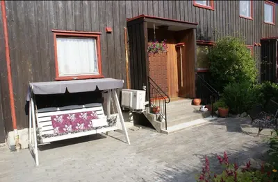 a house with a porch and a window and a building at World championship ski 2025-Cozy house for rent in Trondheim