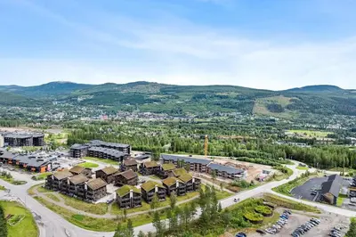 an aerial view of a resort with mountains in the background at Very central and fresh apartment 4 bedr, 10p 2 floors, sauna, ski in and out in Trysil