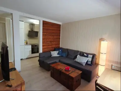 a living room with a couch and a table at Koselig leilighet på Møllenberg in Trondheim