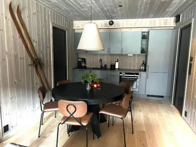 a dining room with a black table and chairs at Hemsedal, sengeplass til 8, ski inn ski out in Hemsedal