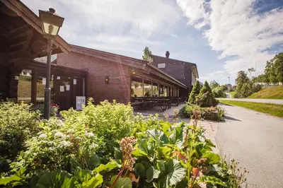 a building with a lot of plants in front of it at Bergmannshuset in Løkken