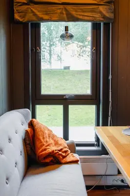 a couch sitting in front of a large window at Bergmannshuset in Løkken