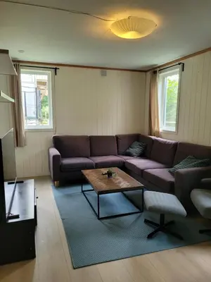 a living room with a couch and a coffee table at 4 and 6 bedroom apartments Ski WC in Trondheim
