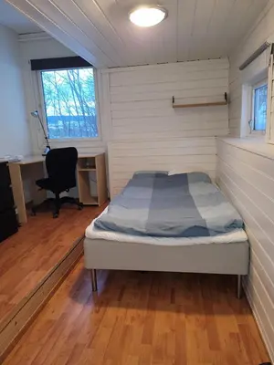 a bedroom with a bed in a room with a desk at 4 and 6 bedroom apartments Ski WC in Trondheim