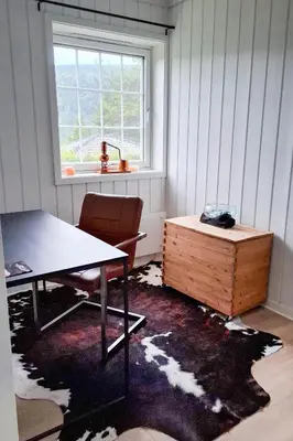 a room with a table and a chest and a window at ThePearl in Sel