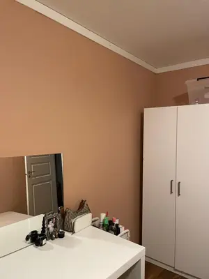 a room with a white cabinet and a mirror at 2 etasjers leilighet in Trondheim