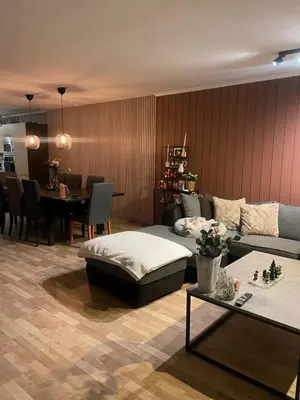 a living room with a couch and a table at 2 etasjers leilighet in Trondheim