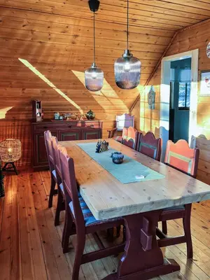 a dining room with a wooden table and chairs at TheHideaway in Sel