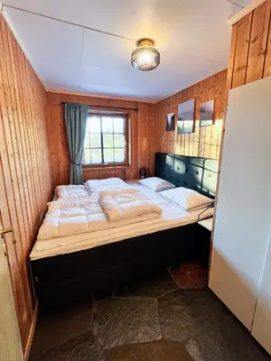 a bedroom with a large bed in a room at TheHideaway in Sel