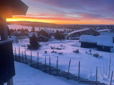 a group of ski poles in the snow at sunset at Apartment Sjusjøen in Sjusjøen