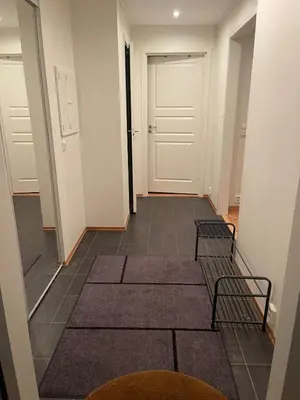 a hallway with white doors and mats on the floor at Apartment Sjusjøen in Sjusjøen