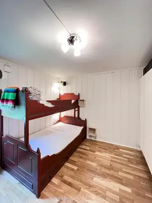a room with two bunk beds and a wooden floor at FourGotten in Sel