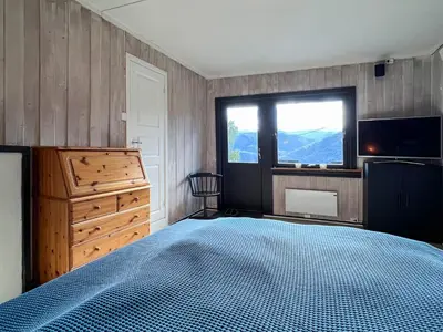 a bedroom with a bed and a dresser and a window at FourGotten in Sel