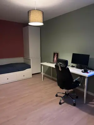 a room with a desk with a computer and a chair at 2 bed apartment in Trondheim