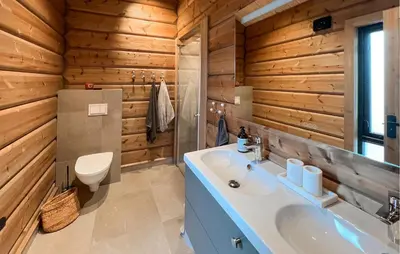 a bathroom with a white sink and wooden walls at Amazing Home In Øyer With Wifi in Øyer