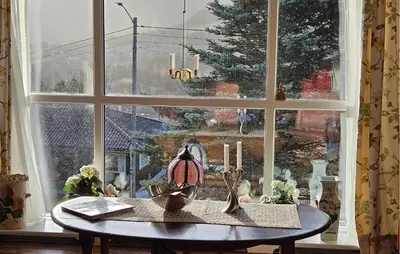 a table in front of a window with a christmas tree at 4 Bedroom Beautiful Home In Hemsedal in Hemsedal