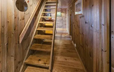 a wooden staircase in a house with a mirror at Amazing Home In Eggedal With Sauna in Eggedal