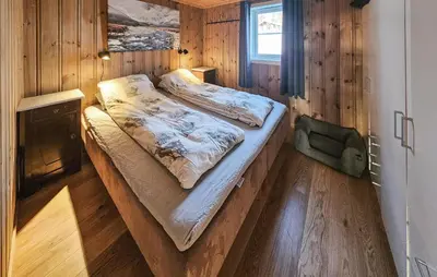 a bedroom with two beds in a wooden room at Amazing Home In Eggedal With Sauna in Eggedal