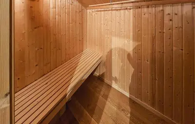 a sauna with wooden walls and a wooden floor at Amazing Home In Eggedal With Sauna in Eggedal