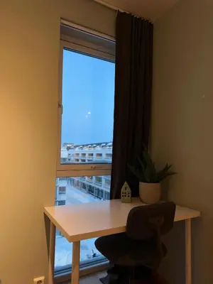 a desk in a room with a window and a chair at Spacious apartment with a great view and parking in Trondheim