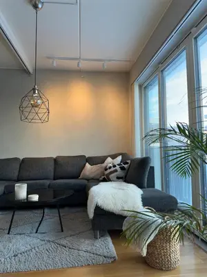 a living room with a couch and a table at Spacious apartment with a great view and parking in Trondheim